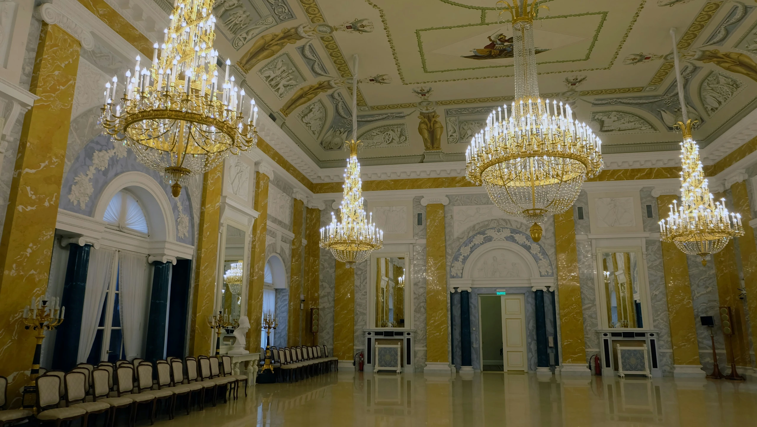 a grand hall decorated in golden and silver