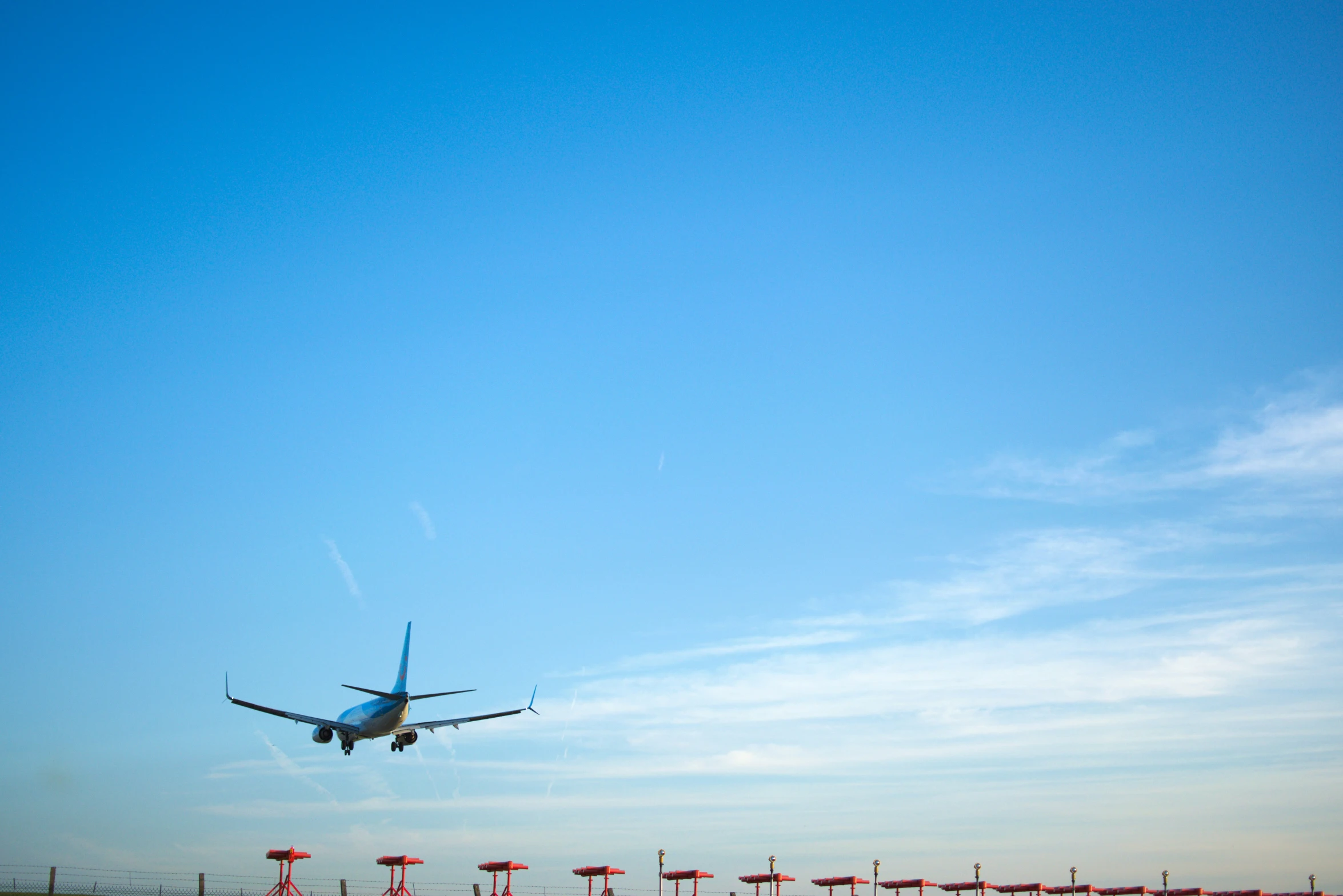 a large jetliner flying through a blue sky