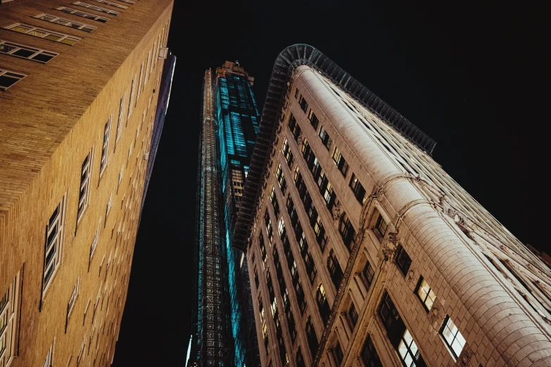 the view of two tall buildings from below