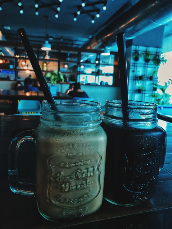 two drinks sit on a table in front of the diner