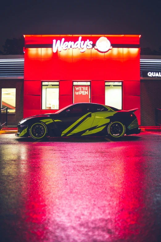 an odd looking car sits in front of a store