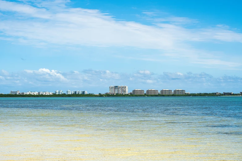 a beautiful view of an ocean with a city in the distance