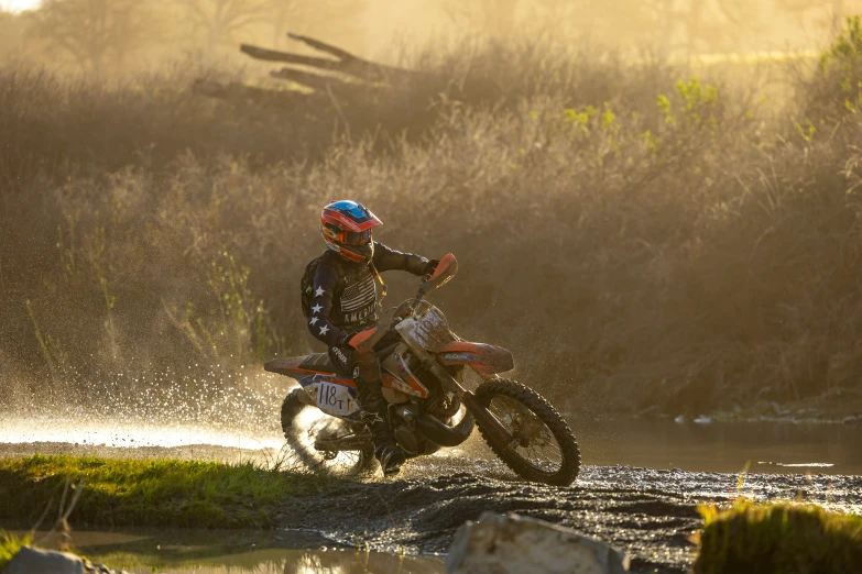 a person is riding a dirt bike across a body of water