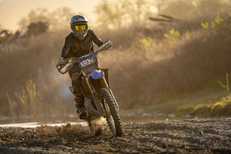 a person on a dirt bike rides on some rocks