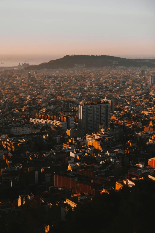 an aerial view of a large city that is next to a hill