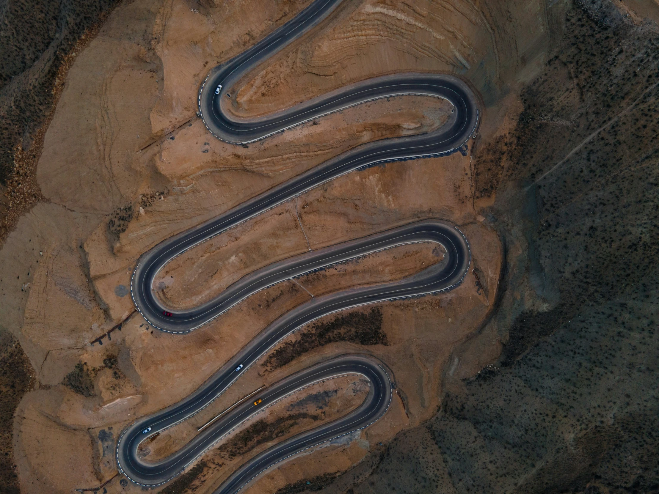 aerial view of winding road in desert area