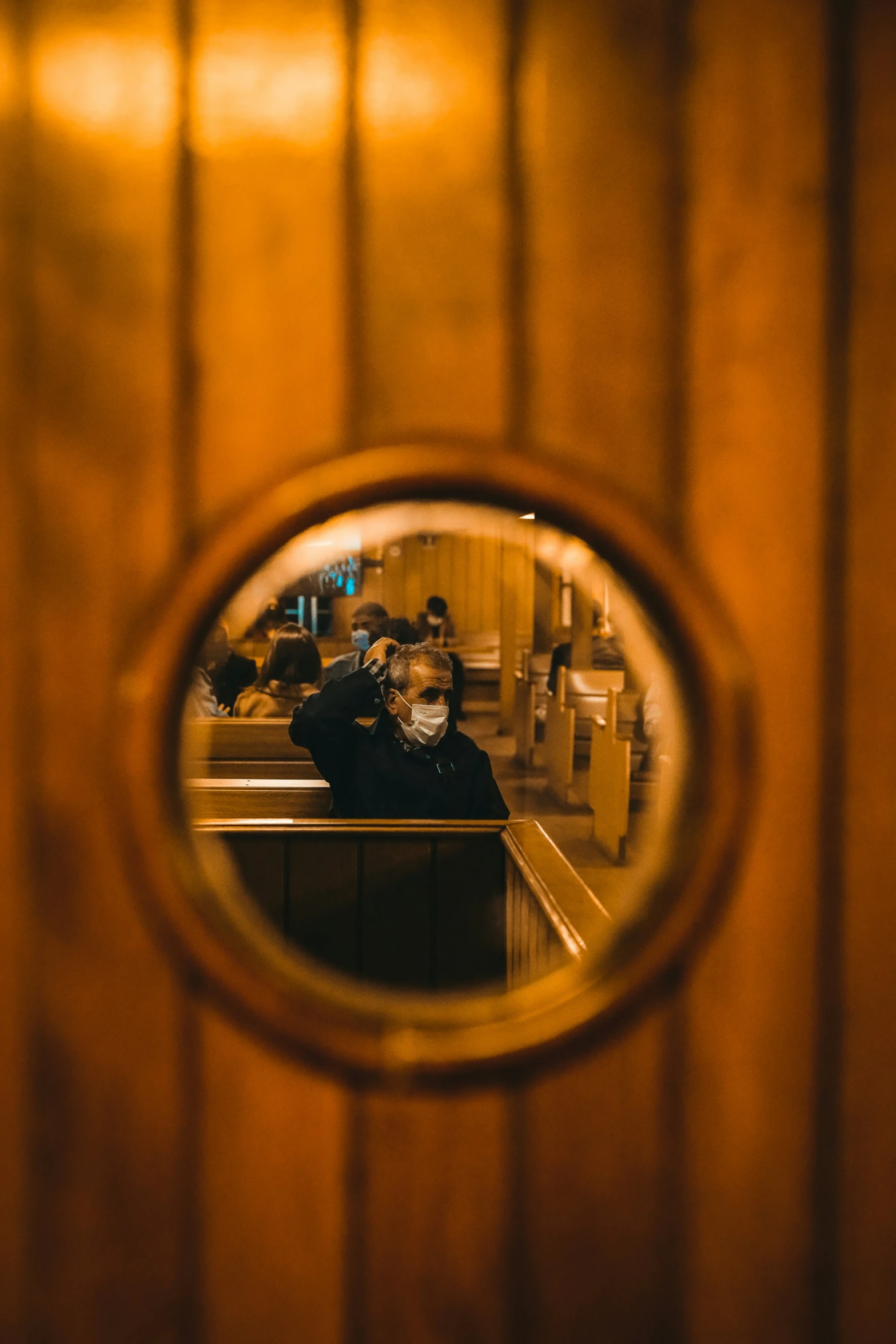 a mirror is seen on a wooden wall