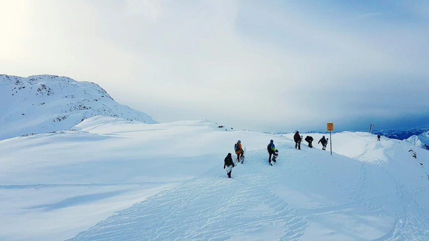 a group of skiers trekking in the snow