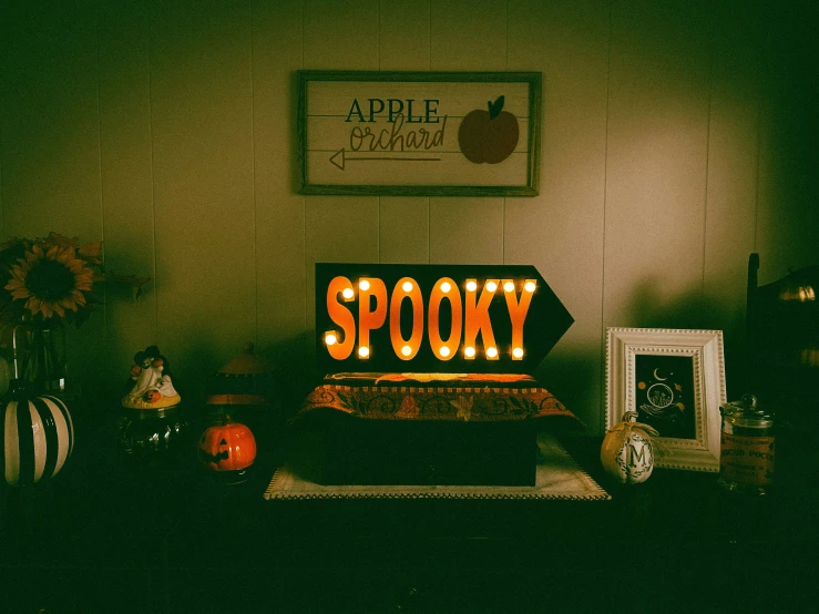 a spooky sign lit up at night time