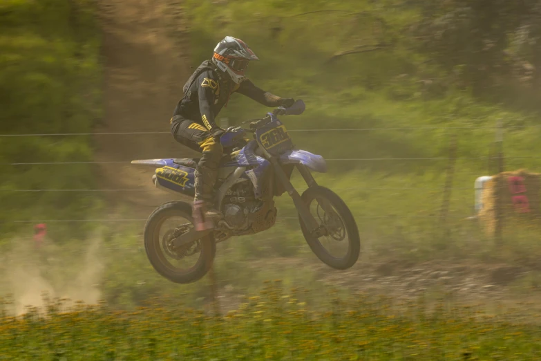 a man on a motorbike is riding through the air