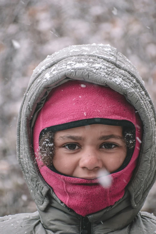 a small child with a winter coat and hood