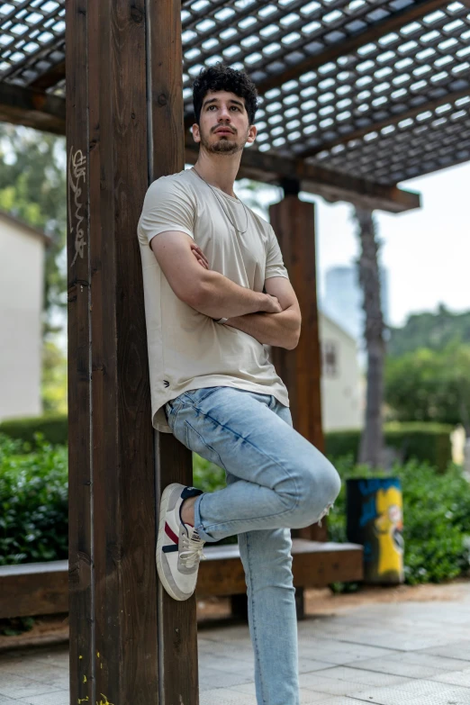 a man leaning on the side of a structure