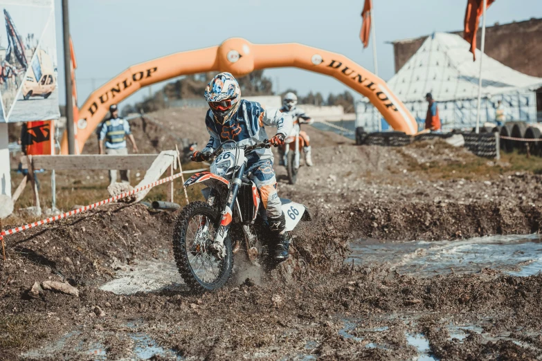 a man riding on the back of a dirt bike