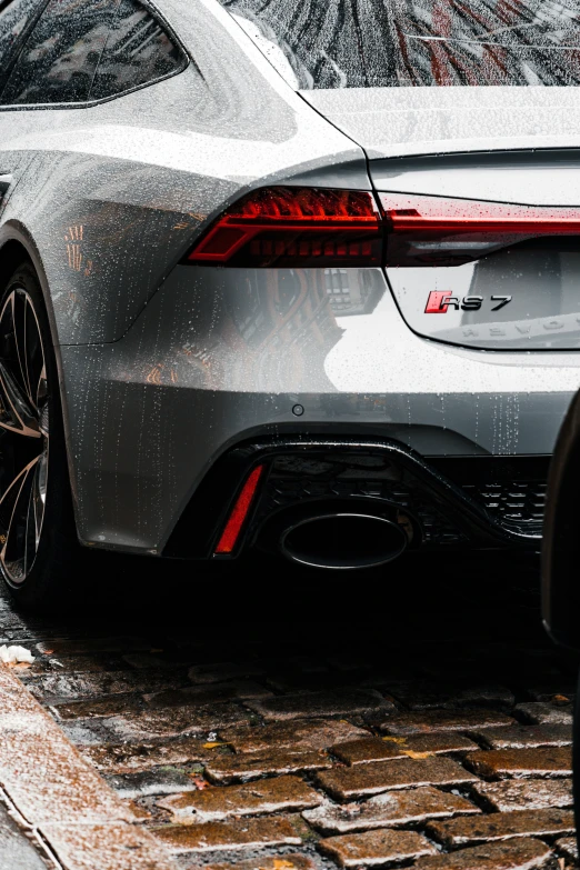 a sports car is parked on a side walk in the snow