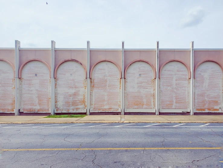 a bunch of old stone arches on the side of a building