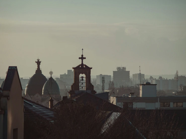 a view of some very tall buildings with a tower in the distance