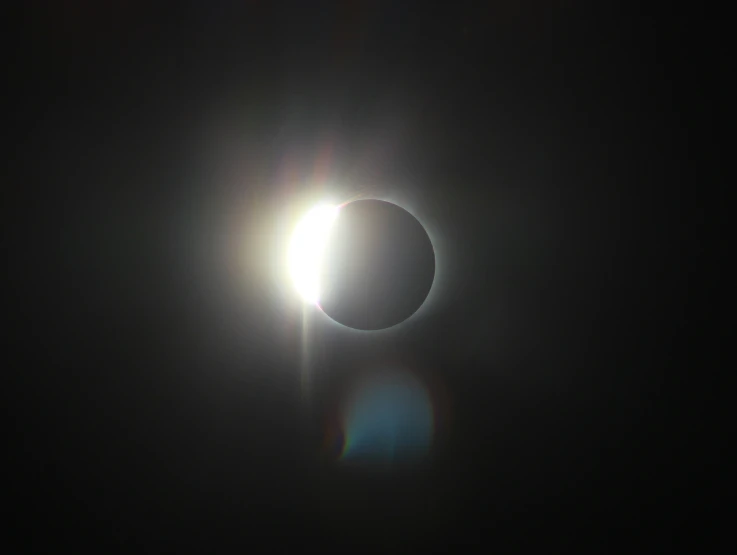 a solar eclipse that is glowing bright and black