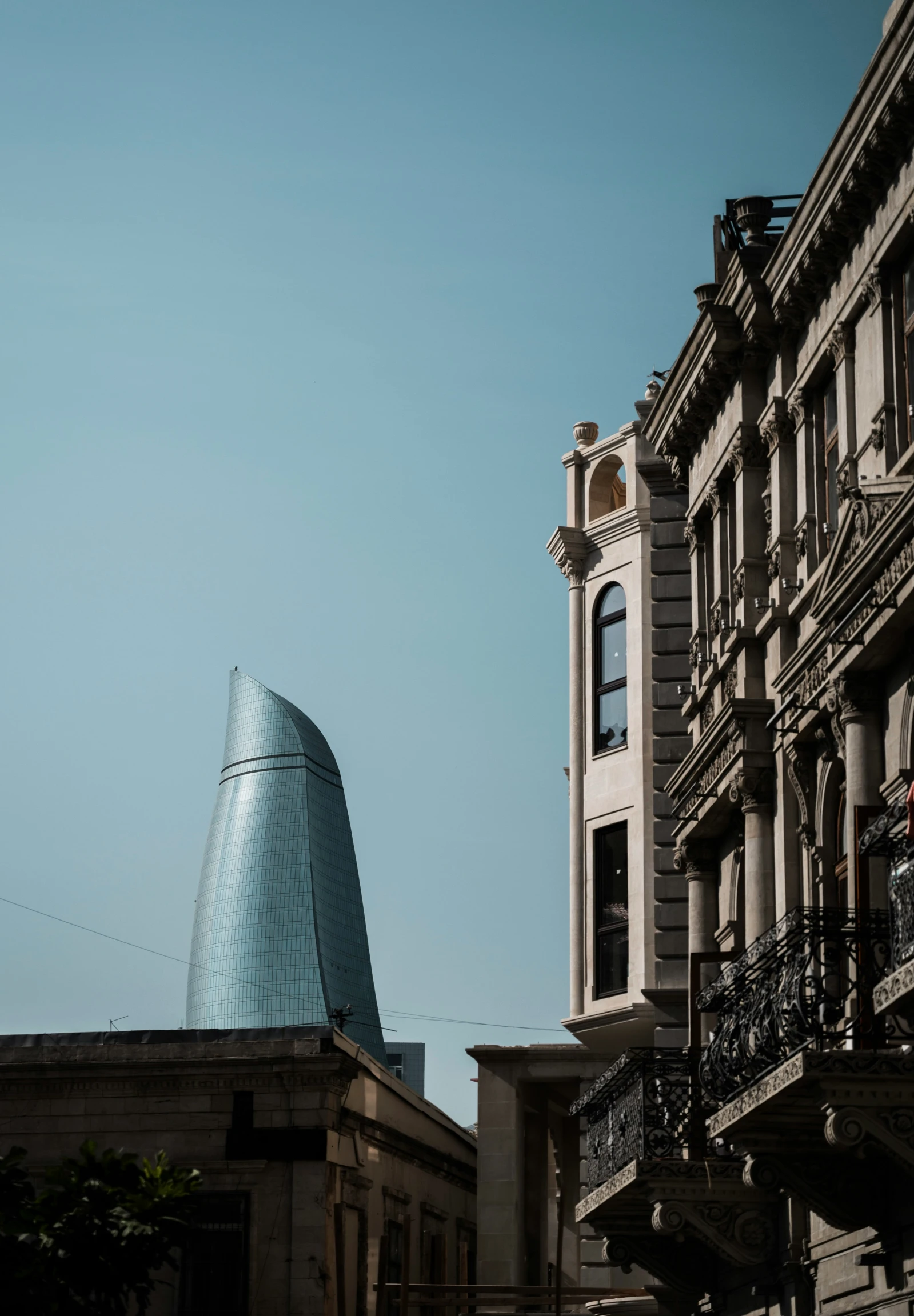 a tall white building next to a blue sky