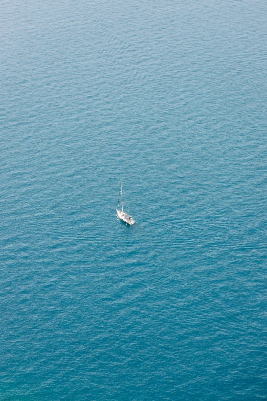 a boat is sailing along the ocean, just out of the water