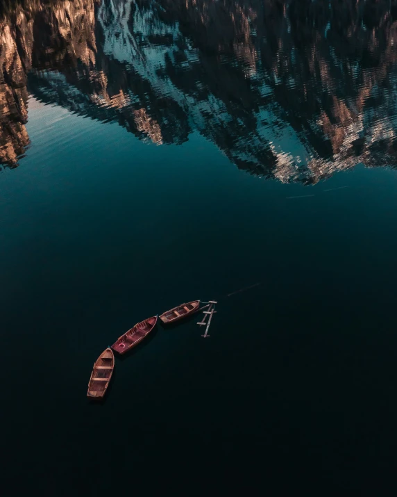a boat is traveling through a lake near mountains