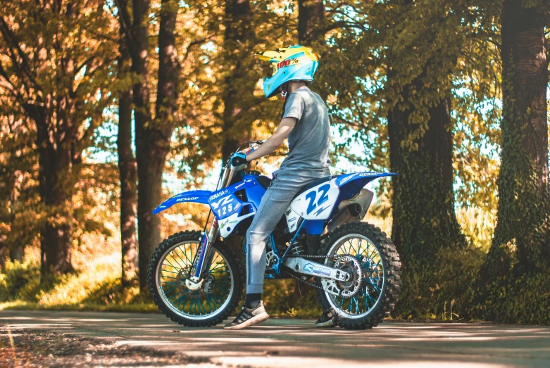 a  rides a blue dirt bike