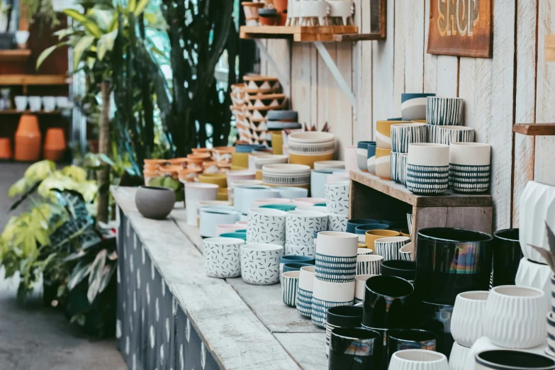 vases and coffee cups are displayed on the shelf