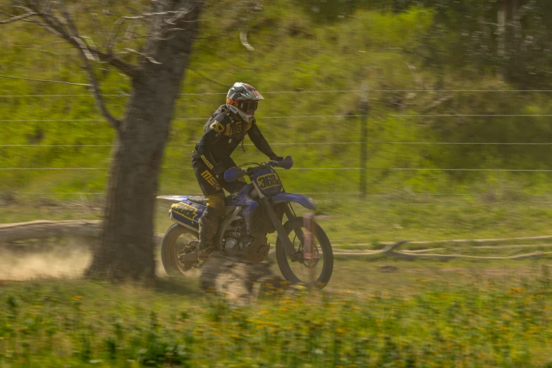 the man on the dirt bike is riding in the mud