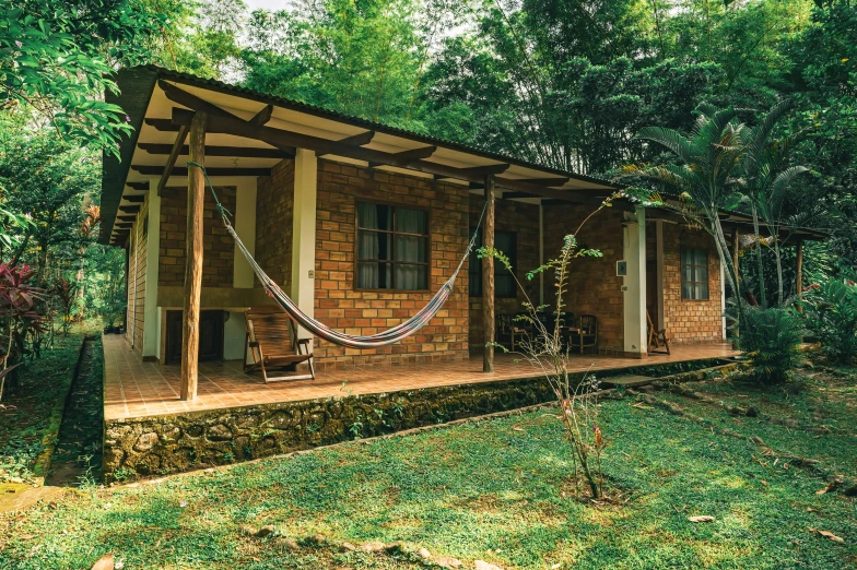 a house with a hammock hanging on the front porch