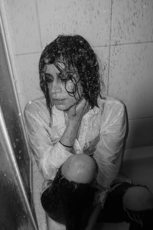 black and white image of a young lady cleaning her face