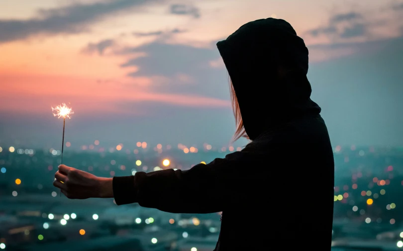 a person holding onto a flower in the air