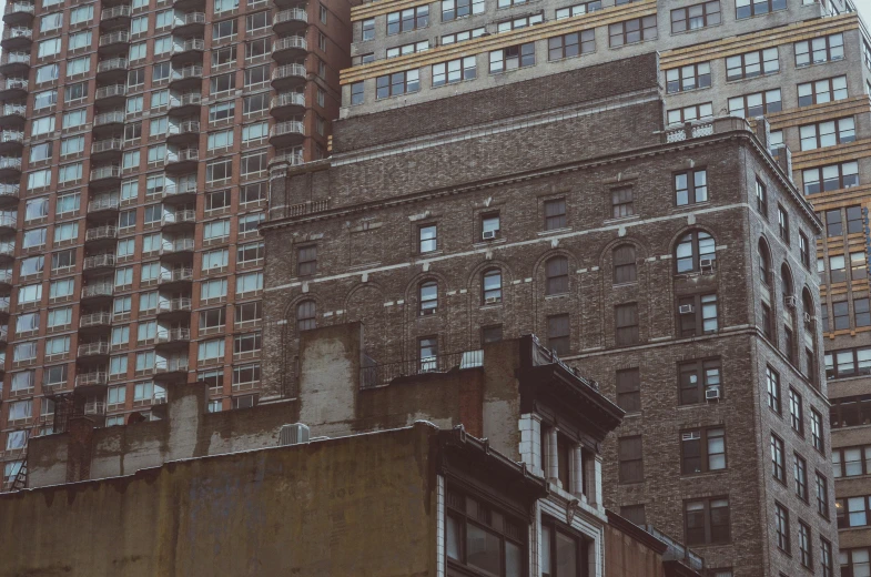 old buildings with very large windows against a cloudy sky