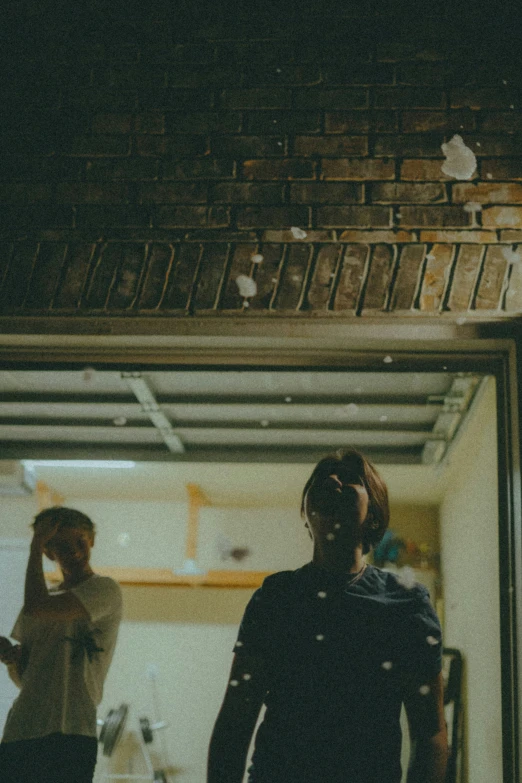 two people are walking into the front door of a building