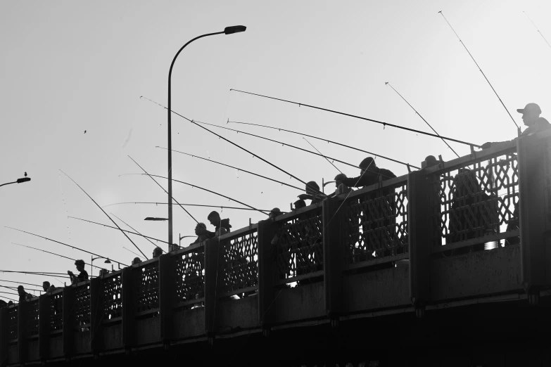 a group of people standing on top of a bridge