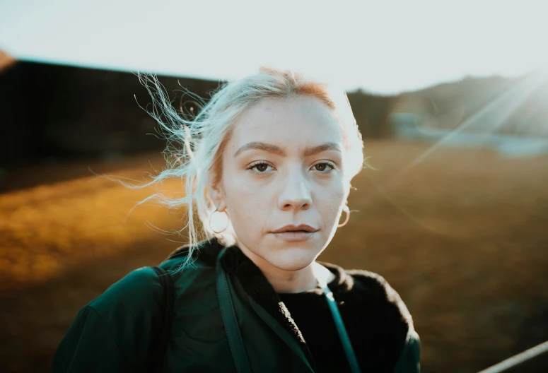 a woman is outside in a grassy field