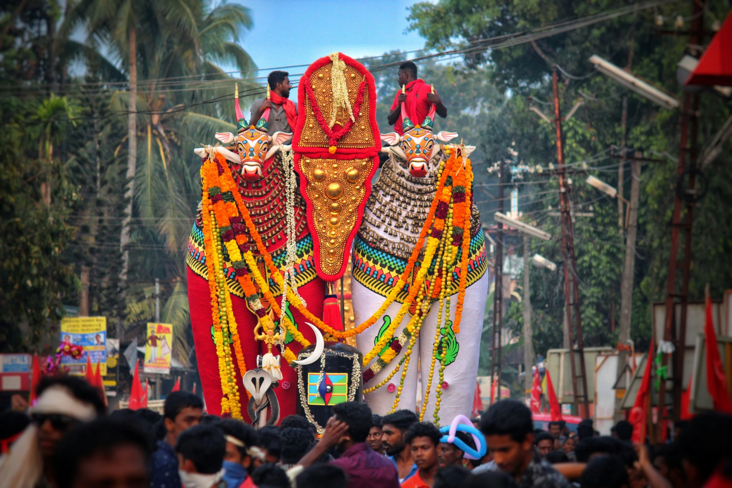 a group of people watching an elephant float through the city