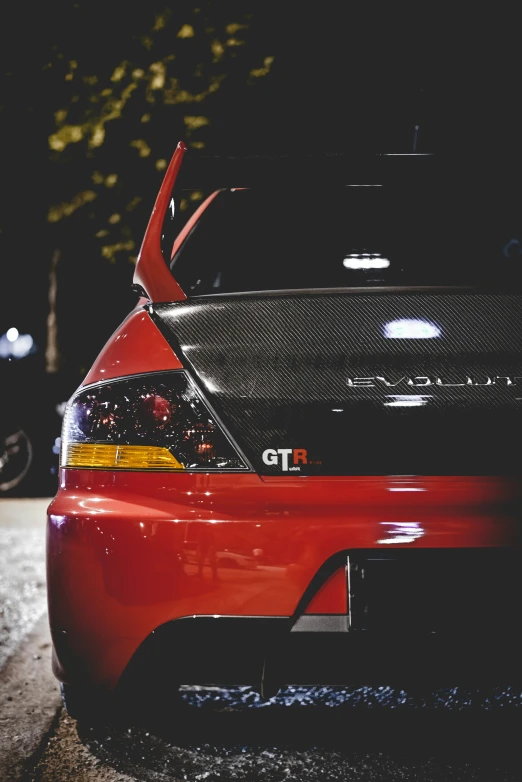 the hood and bumper of an electric car in dark street