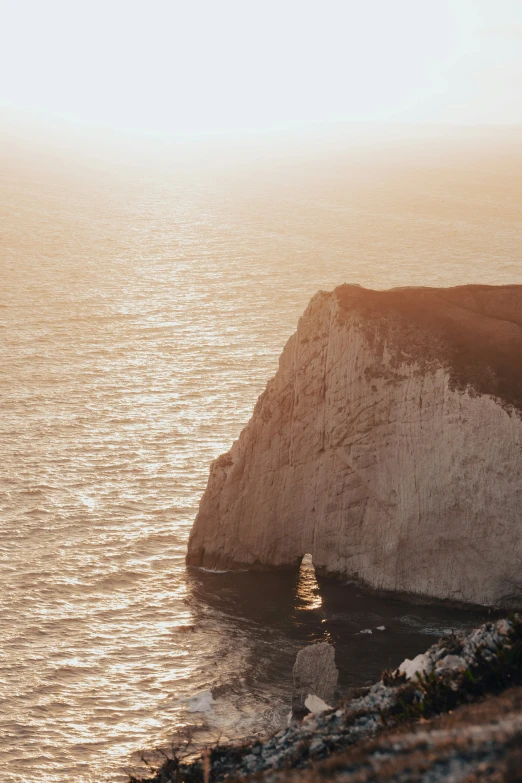 a large body of water near a cliff