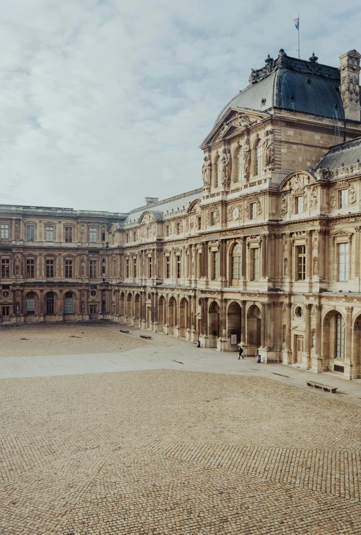 a large building sitting in the middle of a courtyard