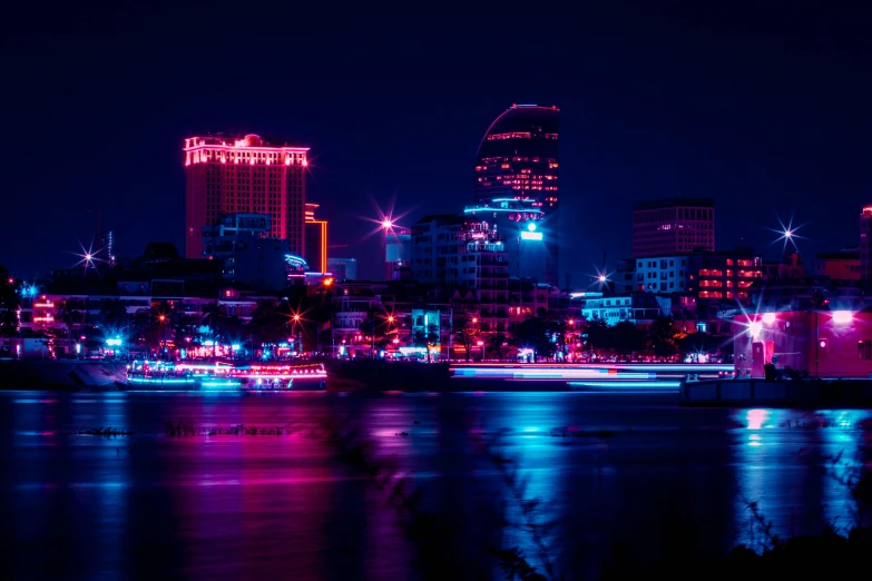 the city at night has neon colored lights on it