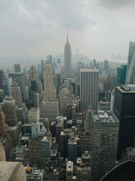 a view from the top of a building shows many tall buildings