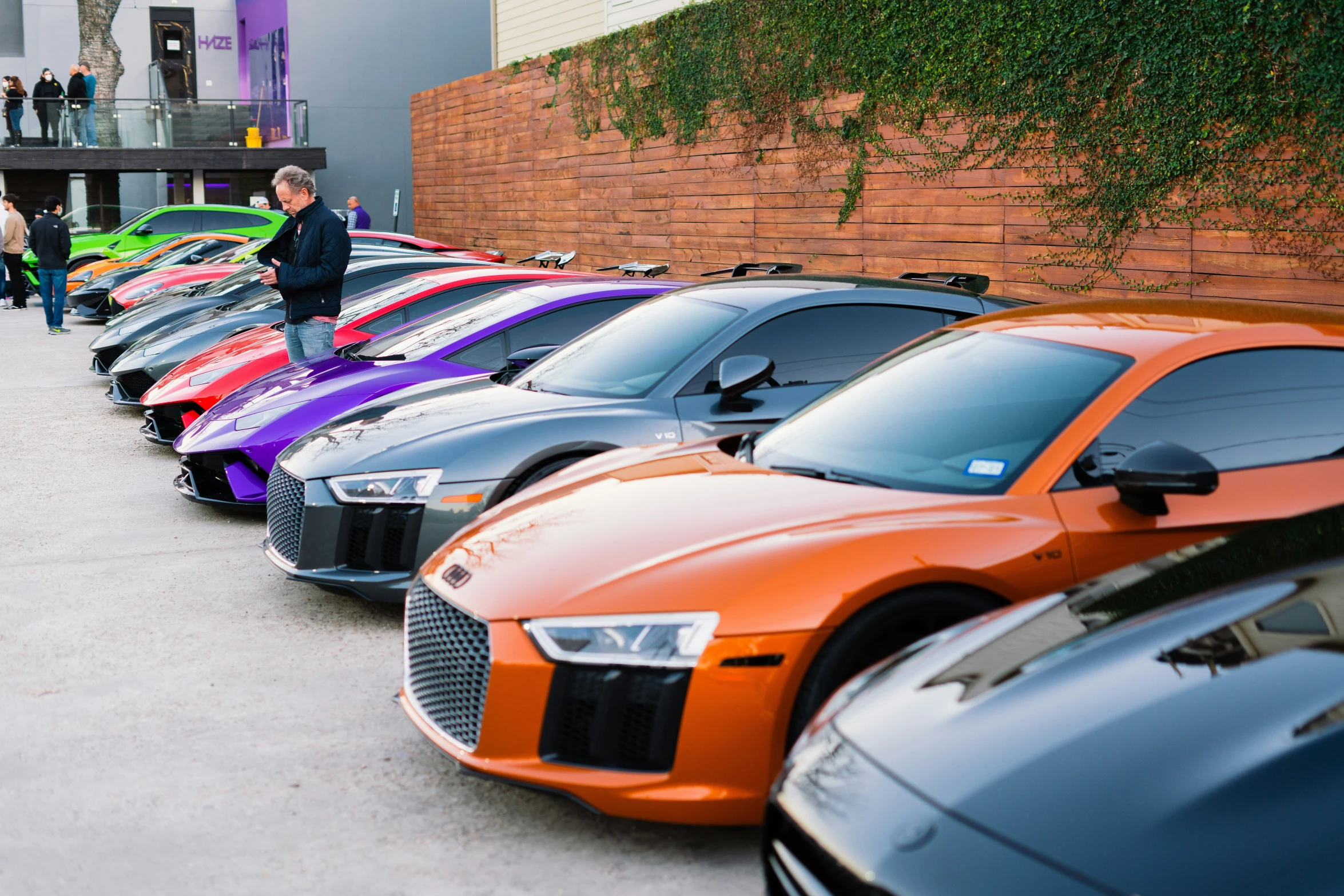 a woman standing next to a line of parked cars