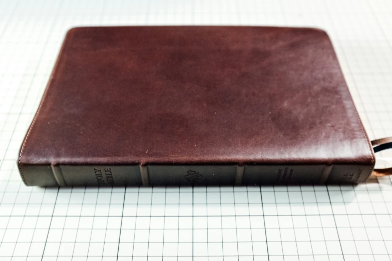 a leather book on a white sheet of graph paper