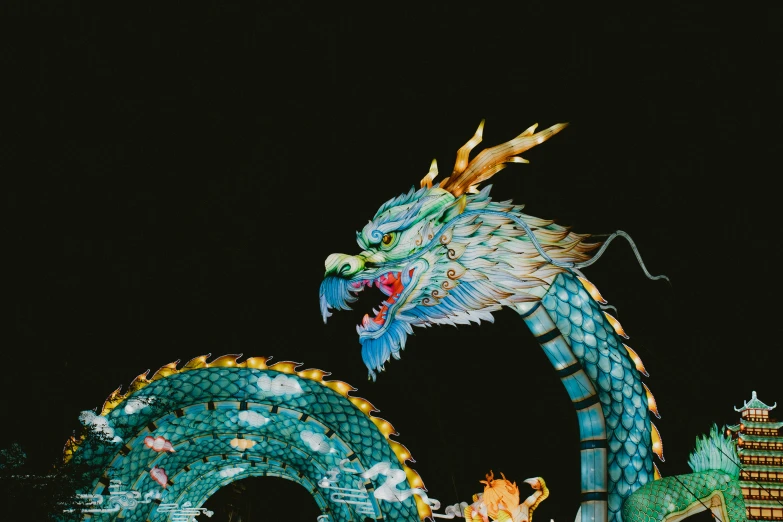 a large blue dragon with its mouth open at night