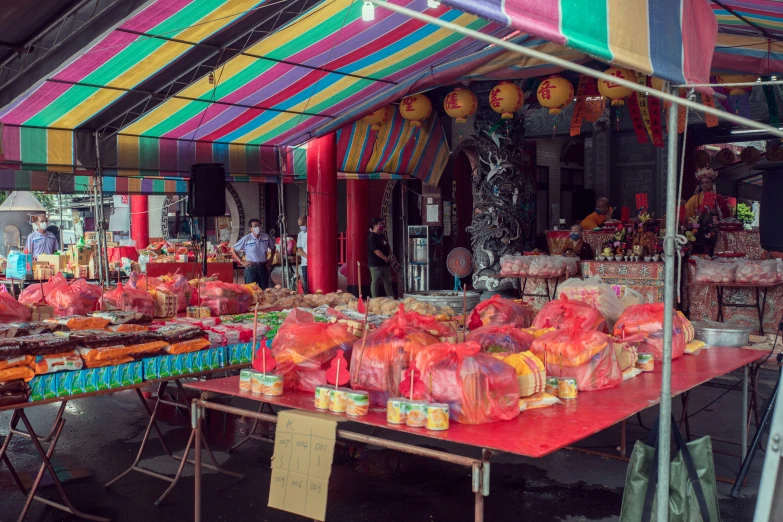 a colorful tent with food on it for sale