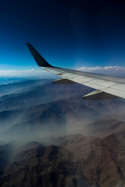 a view from an airplane window over some mountains