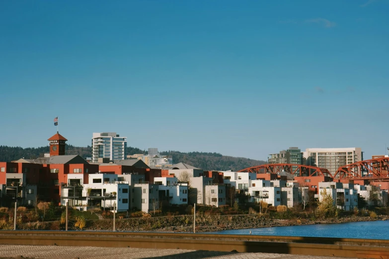 a group of red and white buildings with blue water