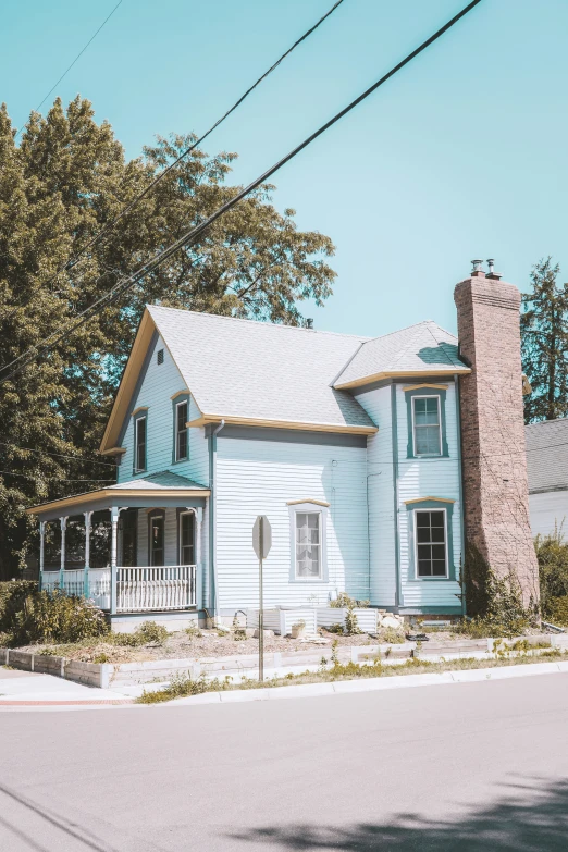 the front of a house painted blue and white