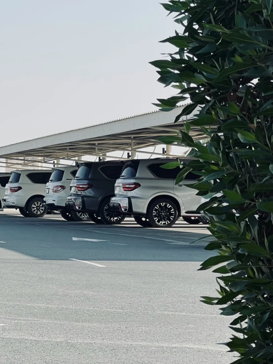 four vehicles lined up in front of a covered area