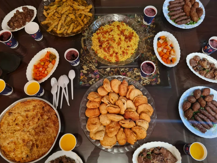 a table with many plates and bowls of food