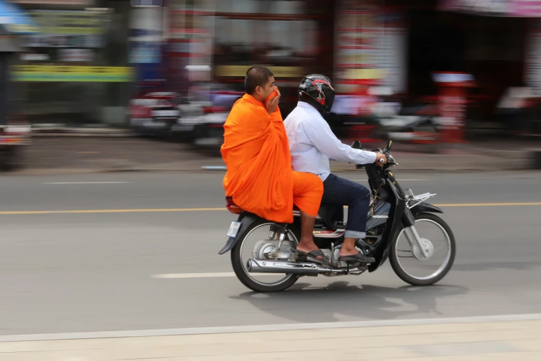 the monk and monk are on the motorcycle